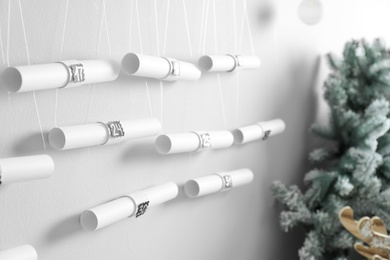 Photo of New Year advent calendar hanging on white wall indoors