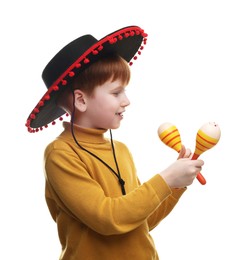 Photo of Cute boy in Mexican sombrero hat with maracas on white background