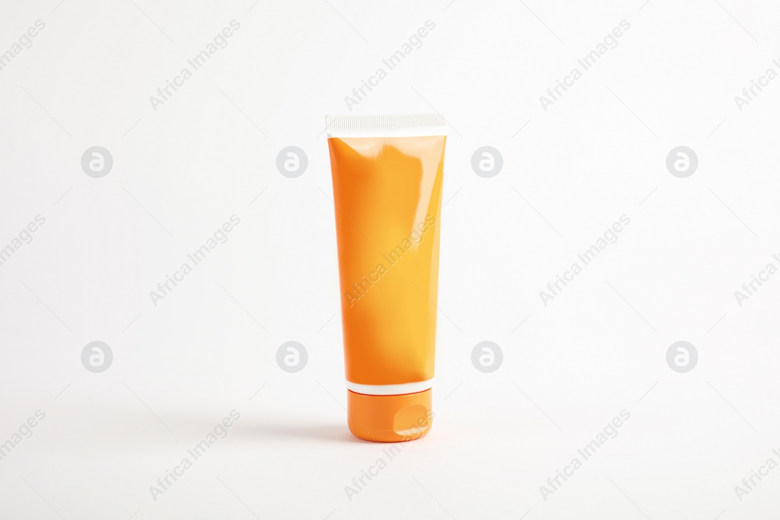 Photo of Tube with sun protection body cream on white background