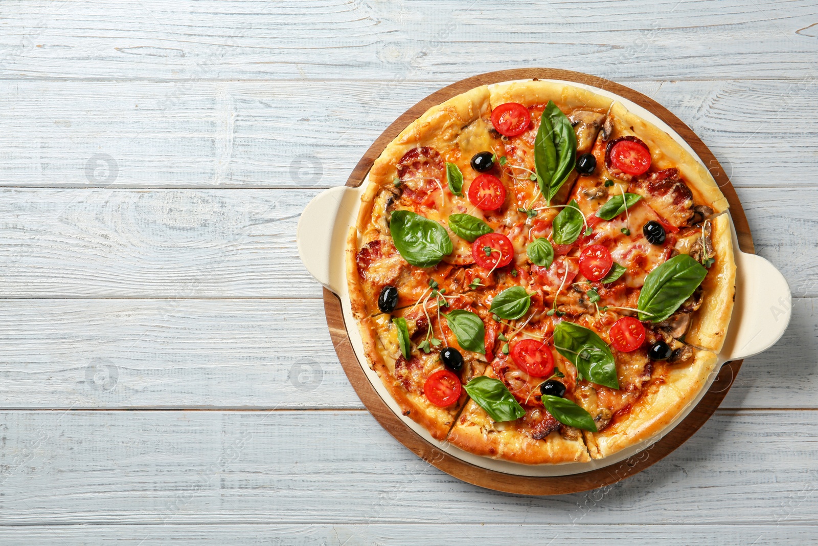 Photo of Tasty homemade pizza and space for text on wooden table, top view