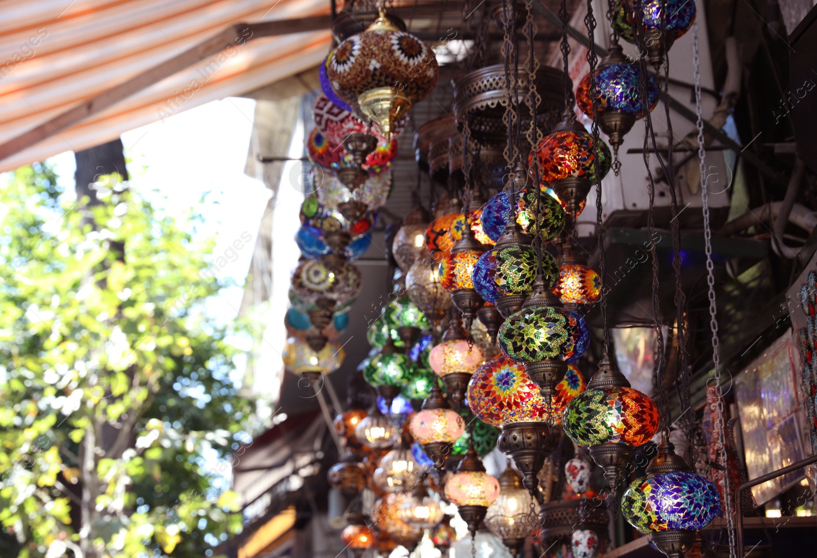 Photo of Souvenir stall with beautiful mosaic lamps, outdoors