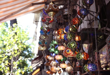 Photo of Souvenir stall with beautiful mosaic lamps, outdoors