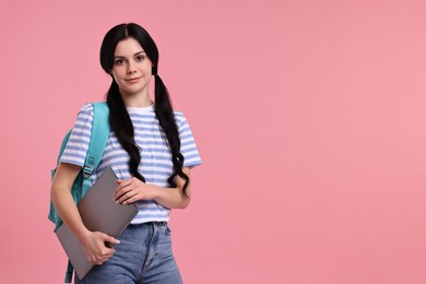 Photo of Student with laptop on pink background. Space for text
