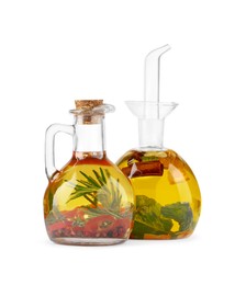 Photo of Different sorts of cooking oil with spices and herbs in bottles on white background