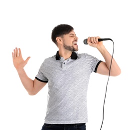 Handsome man in casual clothes singing with microphone on white background