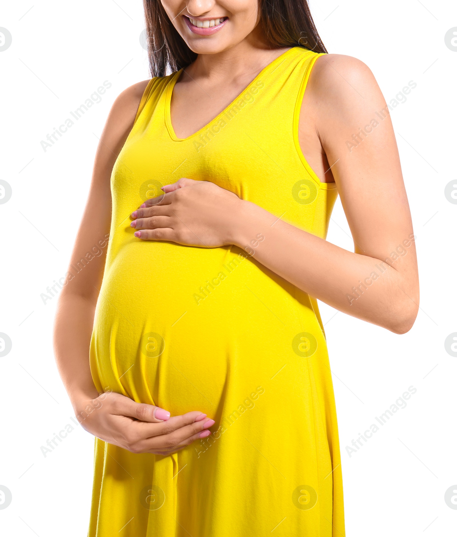 Photo of Young pregnant woman in casual clothes on white background