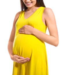 Photo of Young pregnant woman in casual clothes on white background