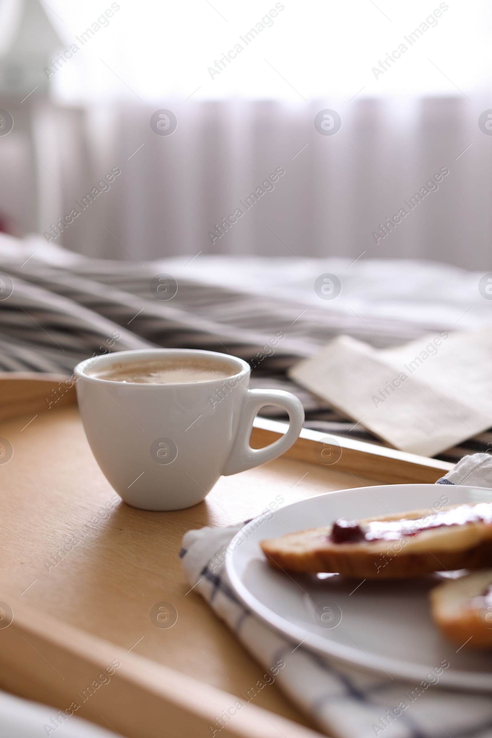 Photo of Morning coffee and sandwiches on tray in bedroom