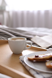 Morning coffee and sandwiches on tray in bedroom