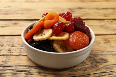 Mix of delicious dried fruits on wooden table, closeup