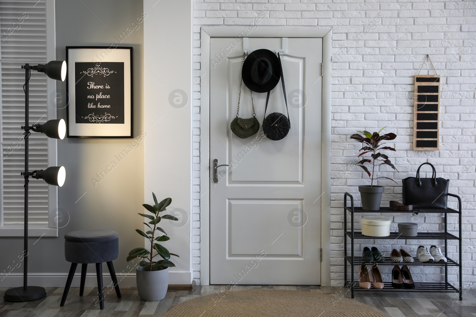 Photo of Hallway interior with stylish furniture, shoes and plants