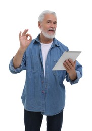 Photo of Man with tablet showing ok gesture on white background