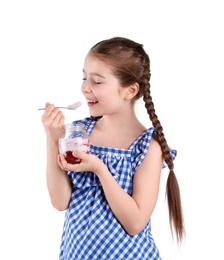 Cute girl eating tasty yogurt on white background