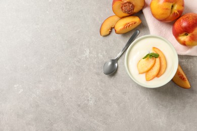 Photo of Delicious yogurt with fresh peach and mint on grey table, flat lay. Space for text