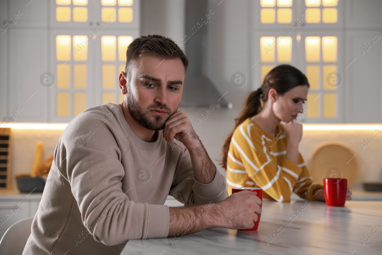 Photo of Young couple quarreling at home. Jealousy in relationship