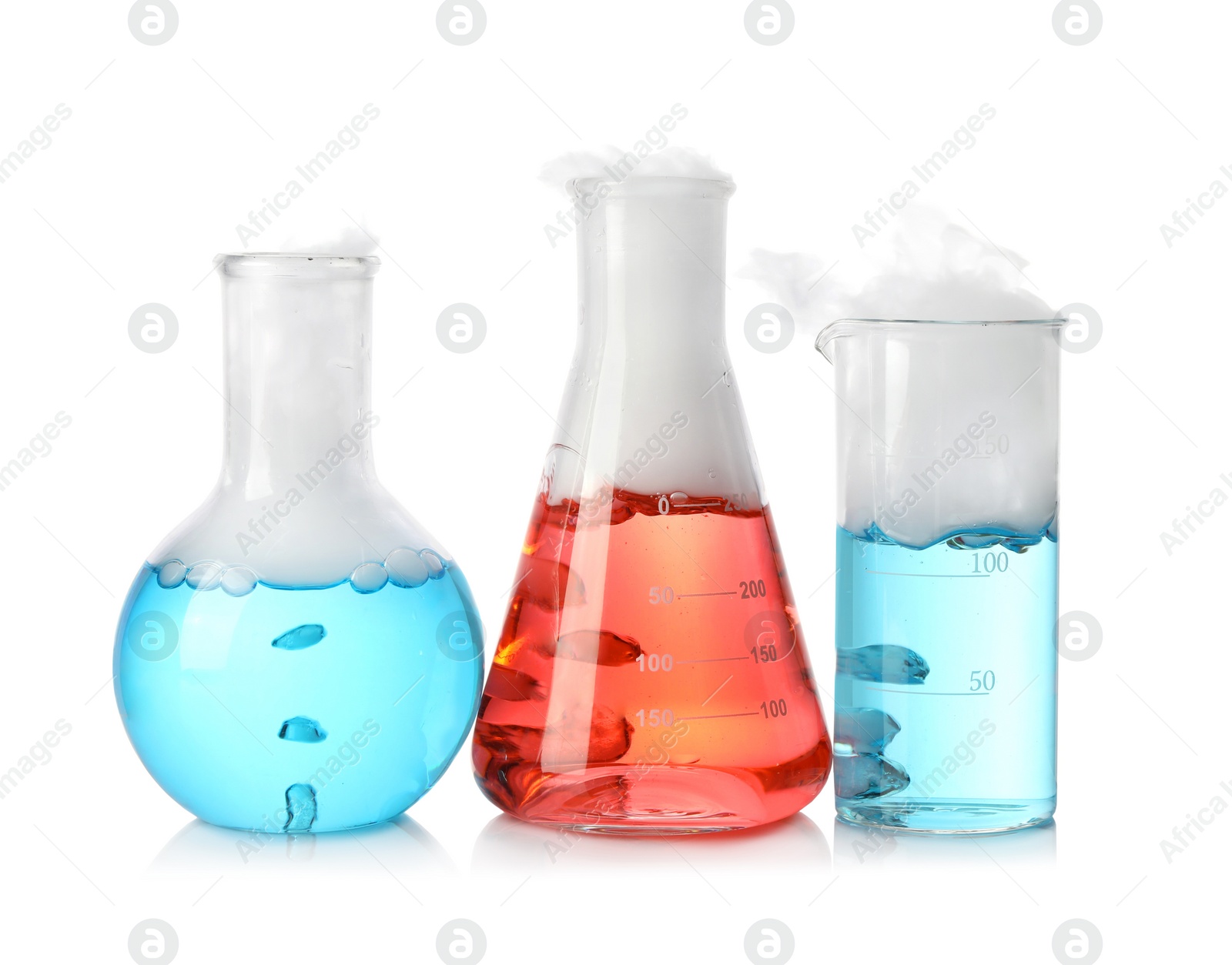 Photo of Laboratory glassware with colorful liquids and steam isolated on white. Chemical reaction