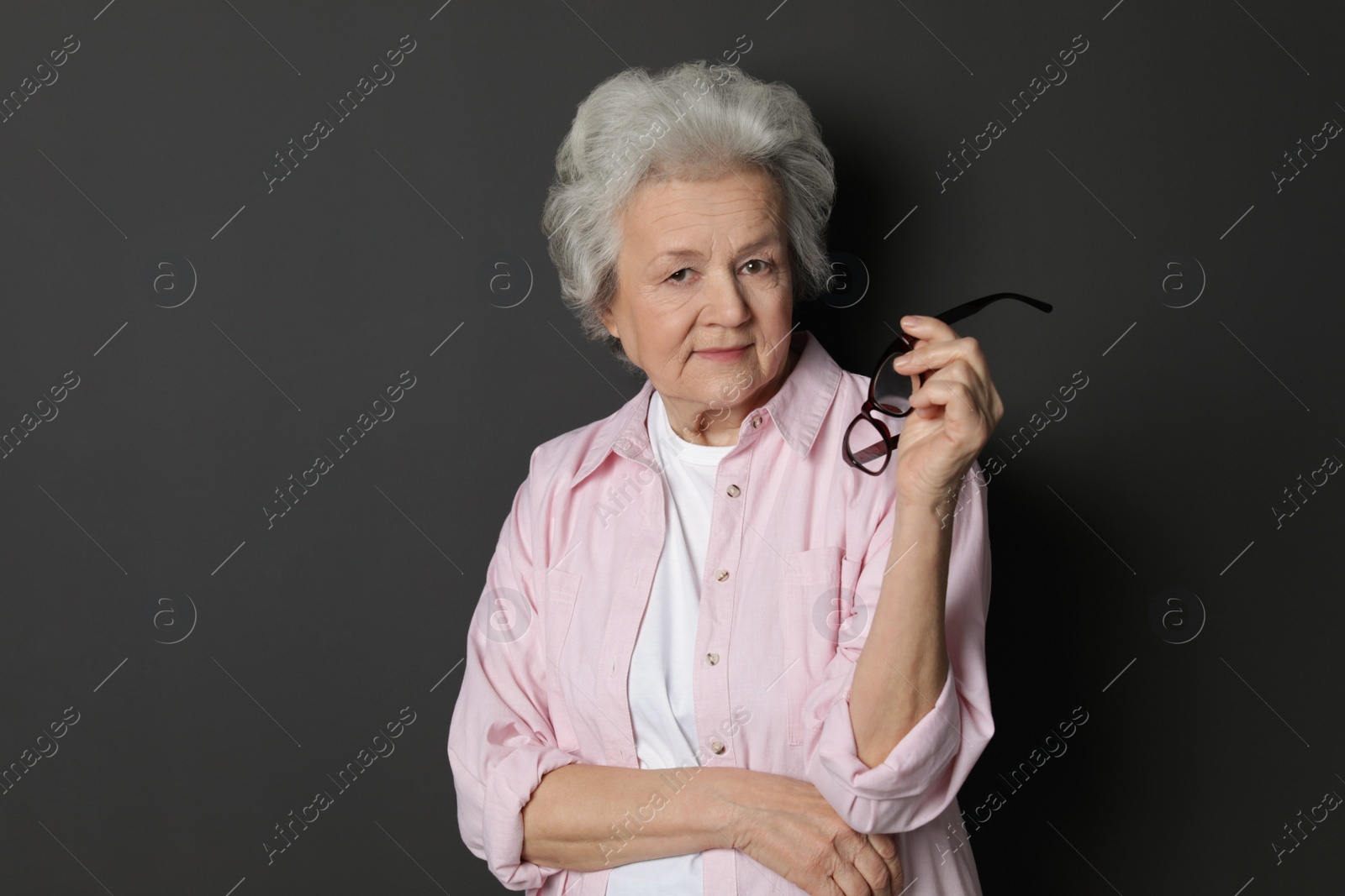 Photo of Portrait of mature woman on black background