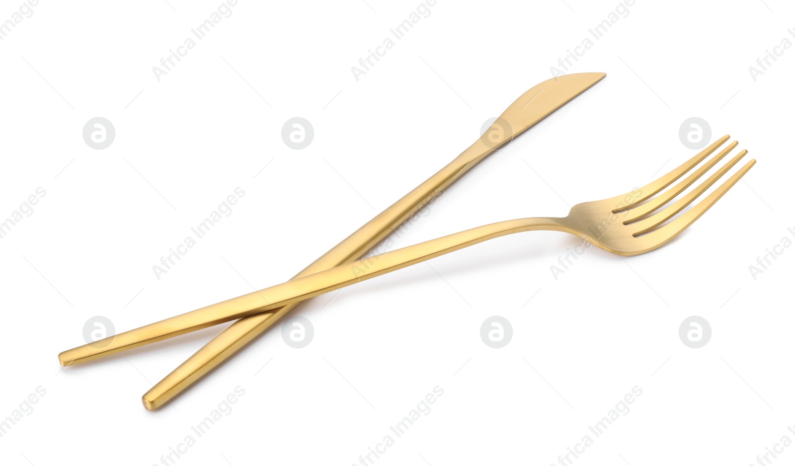 Photo of Shiny golden fork and knife isolated on white. Luxury cutlery