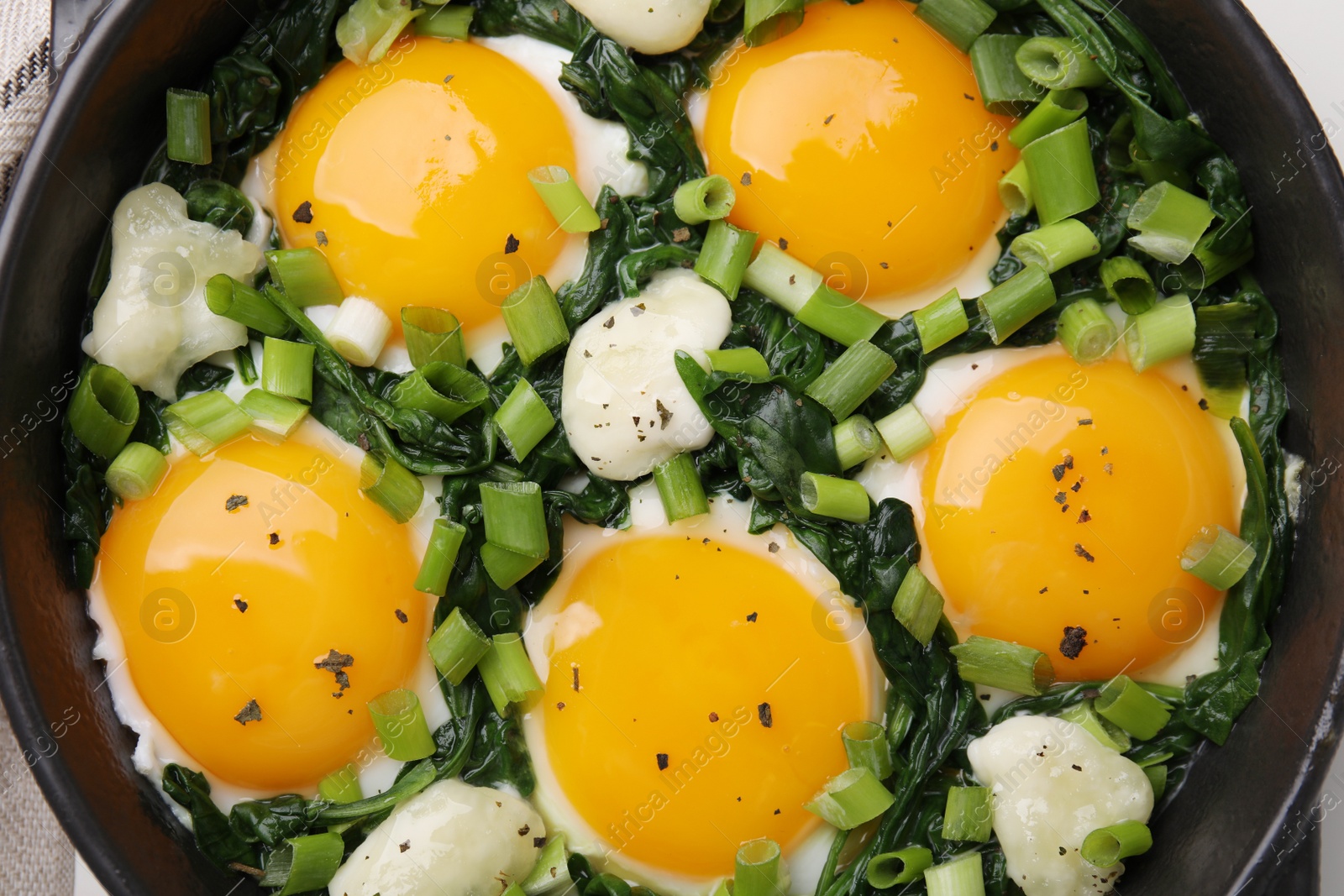 Photo of Tasty green Shakshouka in frying pan, top view