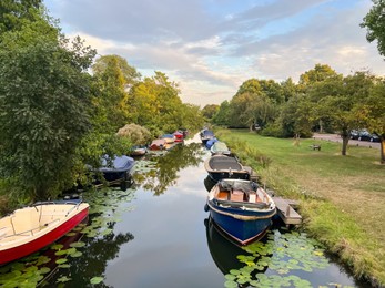 Photo of Beautiful view of moored boats in canal on sunny day