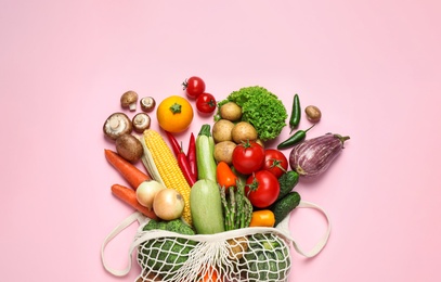 Photo of Different fresh vegetables on pink background, flat lay