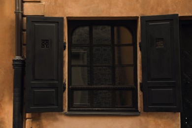 Photo of Window with open shutters in building outdoors