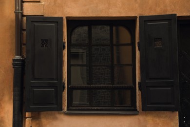 Window with open shutters in building outdoors