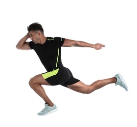 Sporty young man running on white background