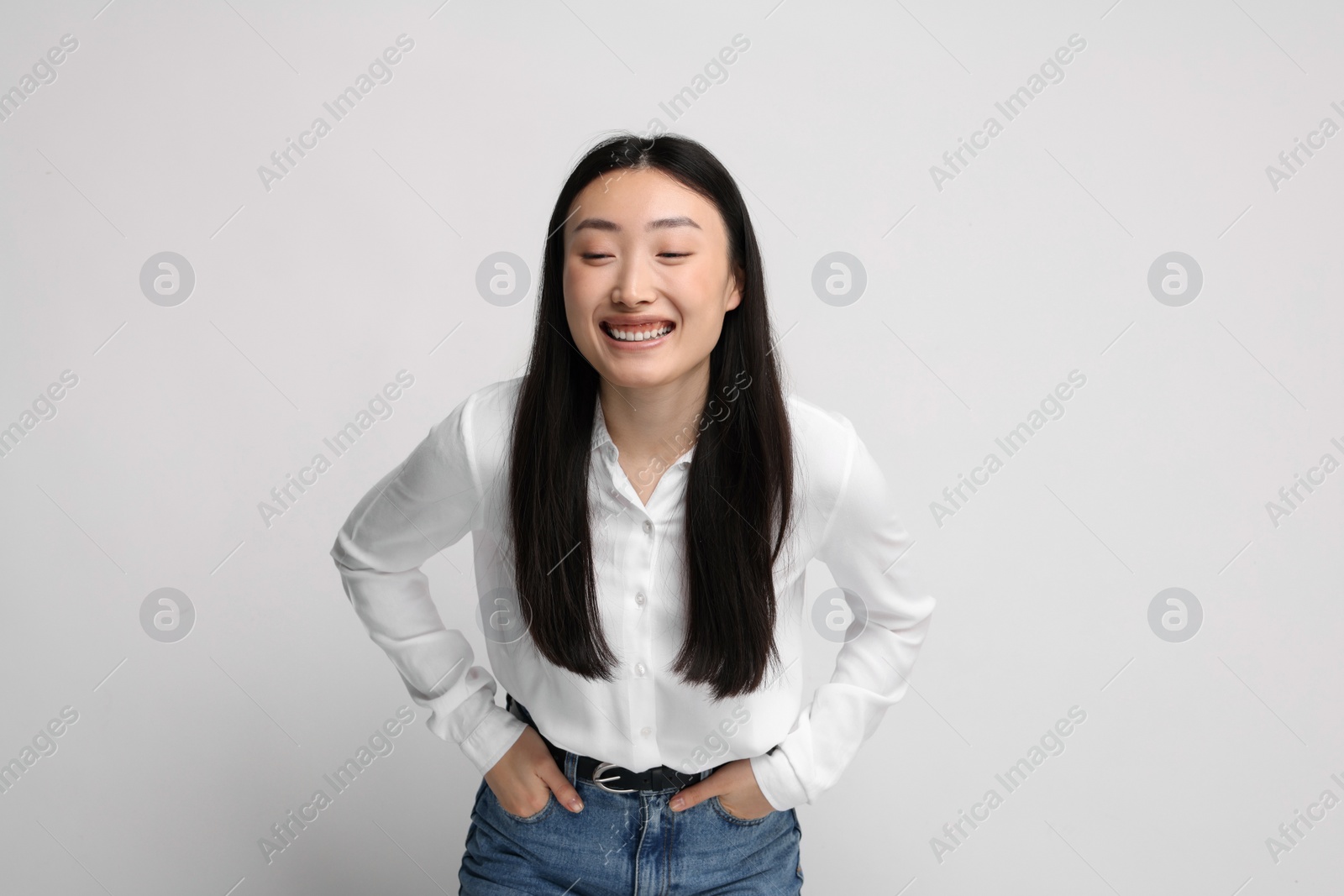 Photo of Portrait of smiling woman on light background