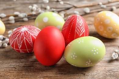 Photo of Colorful painted Easter eggs on wooden table