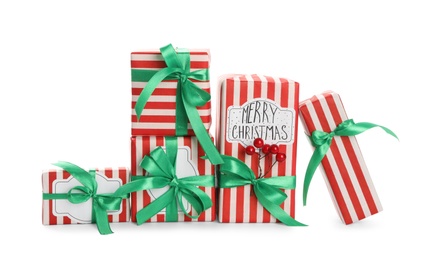 Photo of Christmas gift boxes with green bows and berries on white background