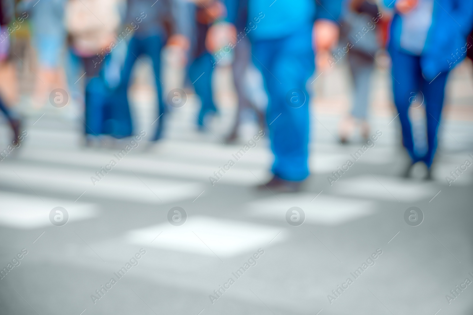 Photo of People crossing street outdoors, closeup. Blurred view