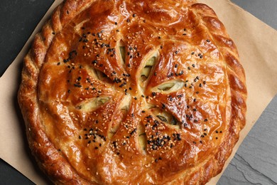 Photo of Tasty homemade pie with filling on grey table, top view