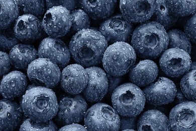 Photo of Wet fresh blueberries as background, top view