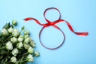 Photo of 8 March greeting card design with red ribbon and roses on light blue background, flat lay. International Women's day