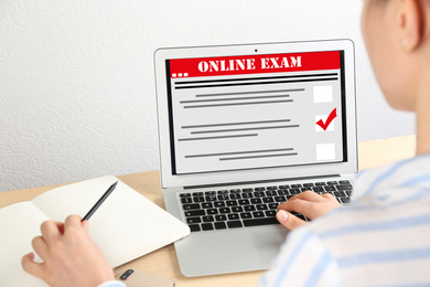 Image of Student passing online exam at home, closeup
