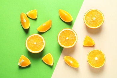 Flat lay composition with ripe oranges on color background