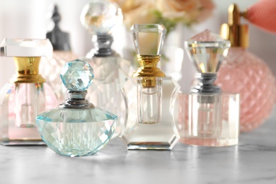 Photo of Many different perfume bottles on dressing table