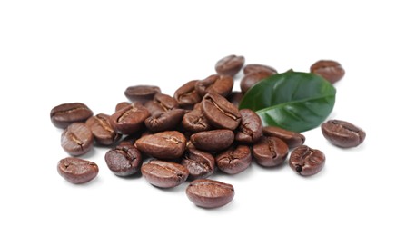 Photo of Pile of roasted coffee beans with fresh leaf on white background