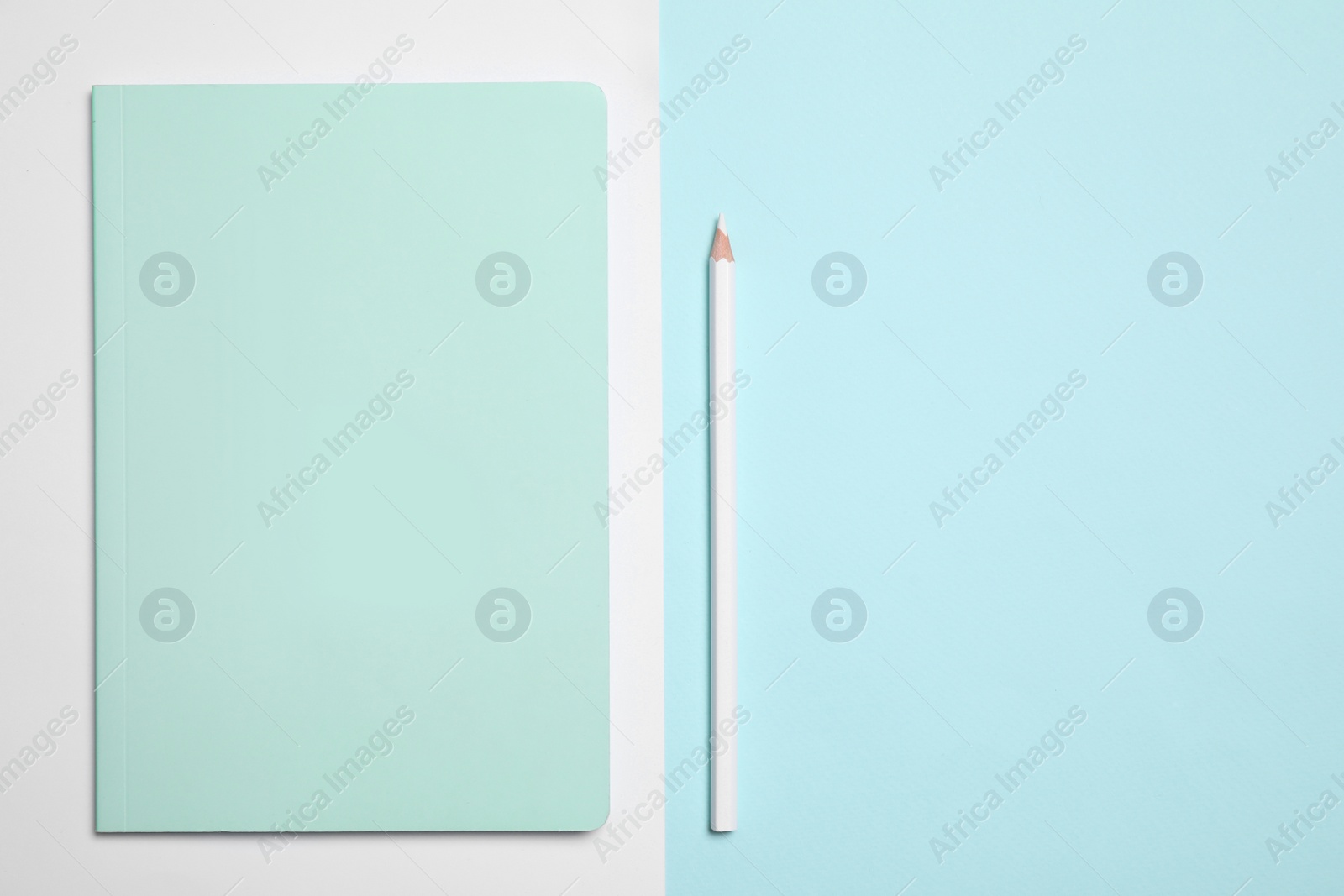 Photo of Stylish notebook and pencil on color background, flat lay. Space for text