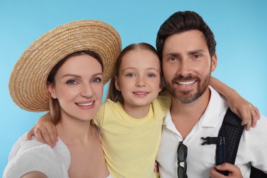 Happy family taking selfie on light blue background