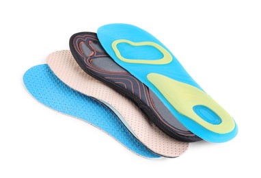 Photo of Four different shoe insoles on white background