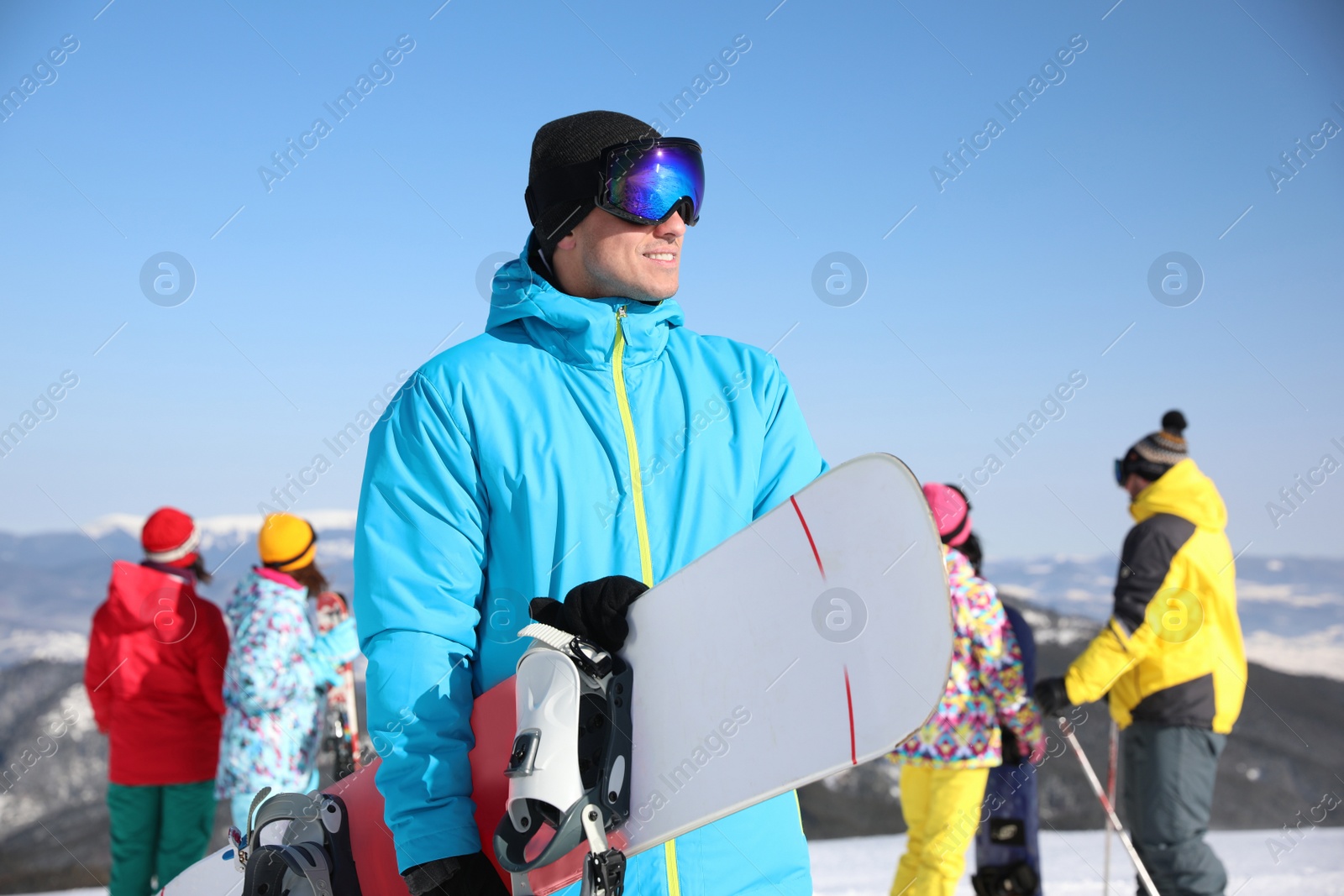 Photo of Man with snowboard at ski resort. Winter vacation