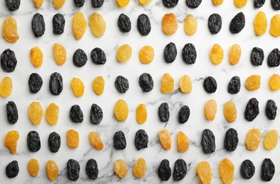 Photo of Flat lay composition with raisins on marble background. Dried fruit as healthy snack