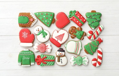 Photo of Many different delicious Christmas cookies on white wooden table, flat lay