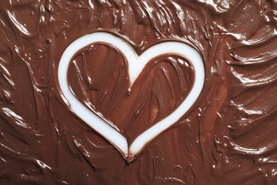 Photo of Heart drawn in milk chocolate on white background, top view
