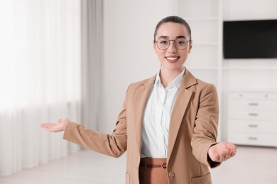 Photo of Happy real estate agent showing new apartment