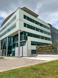 Photo of Beautiful modern building on city street on cloudy day