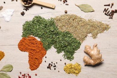 Photo of Continents of different spices and products on wooden table, flat lay