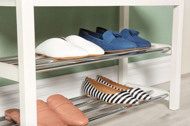 Modern rack with different female shoes indoors